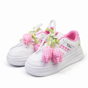Pair of girls white casual sneakers with pink tulip flower accessories.