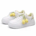 Pair of girls white sneakers featuring yellow gingham tulip charms and floral embroidery.
