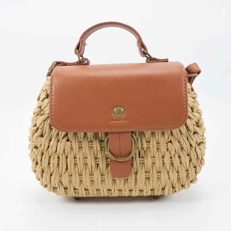 Front view of women's natural beige woven straw tote bag with ring decoration in Bangladesh