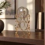 Luxury gold metal glass decorative showpiece on a display shelf