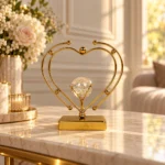 Gold double heart crystal ball showpiece on luxury console table