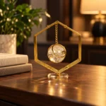 Gold hanging crystal orb decorative showpiece on executive desk