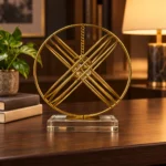 Gold orbital crystal ball showpiece on walnut shelf