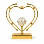 Luxury gold double heart crystal ball decorative showpiece on white background